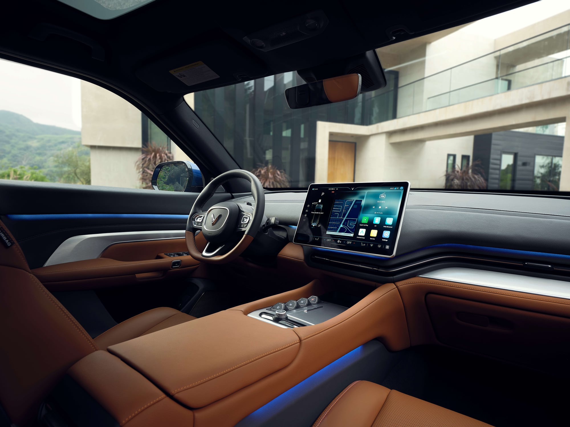 VinFast VF 9 cabin with blue ambient lighting along the dashboard and doors