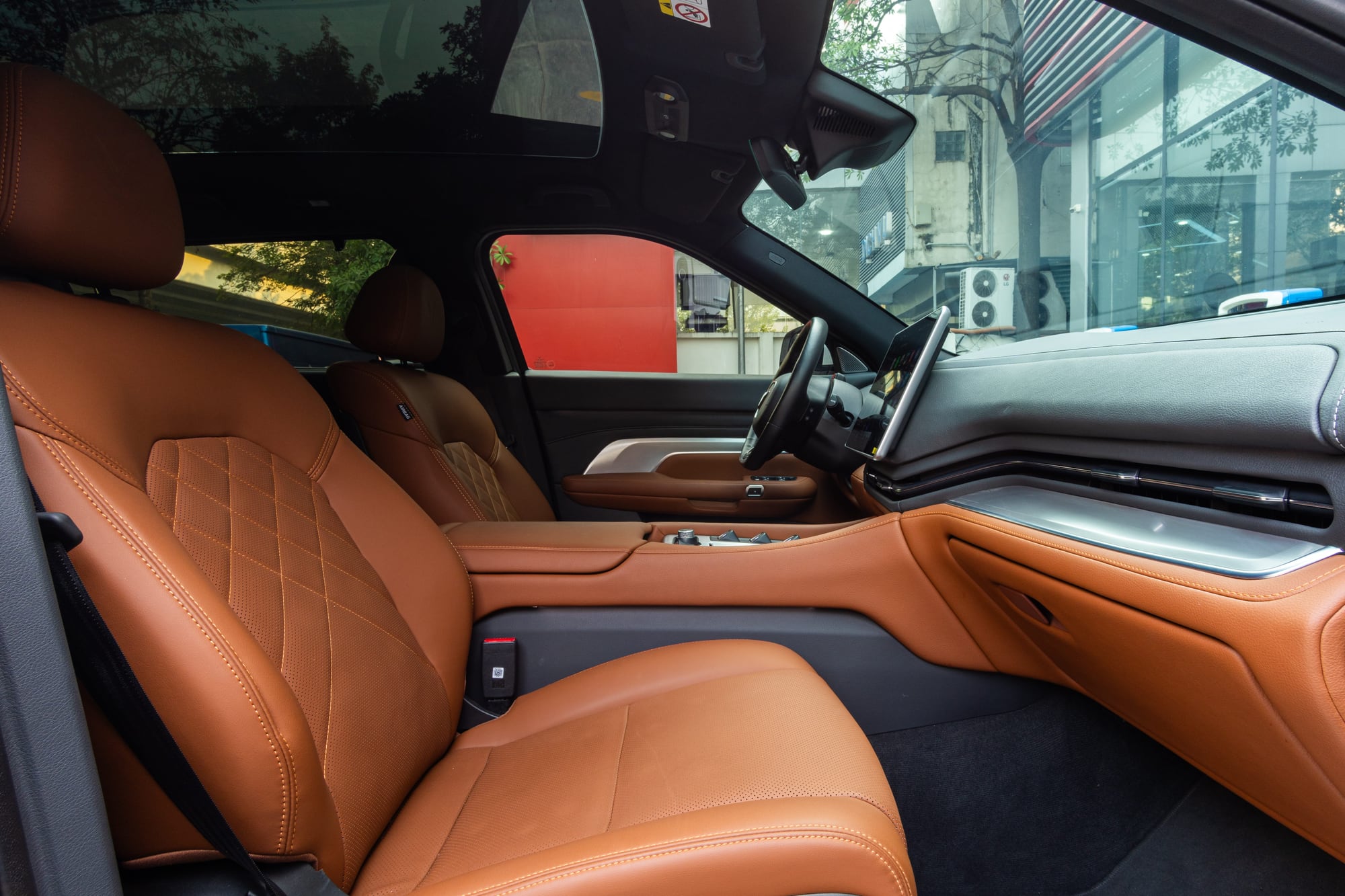 VinFast VF 9 front seats in brown vegan leather, seen from the driver door